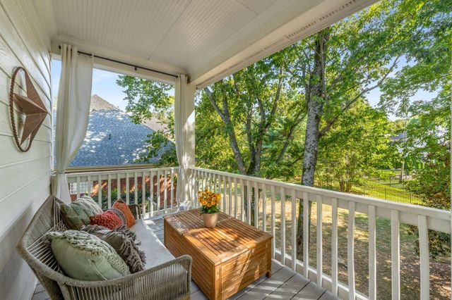 a balcony with furniture and a potted plant
