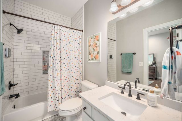 a large bedroom with a bed and a window