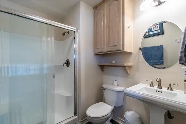 a bathroom with a sink toilet and shower