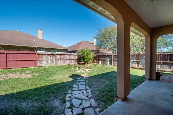 a view of a house with a backyard