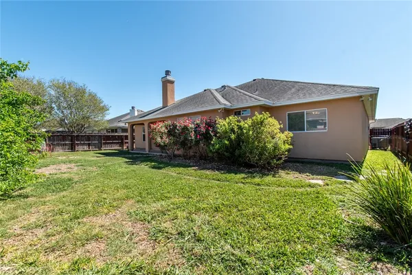 a front view of house with yard and outdoor seating