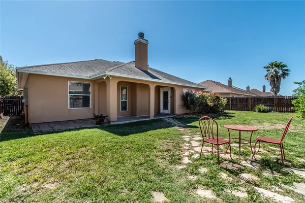 a front view of house with a garden and patio