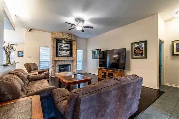 a living room with fireplace furniture and a flat screen tv