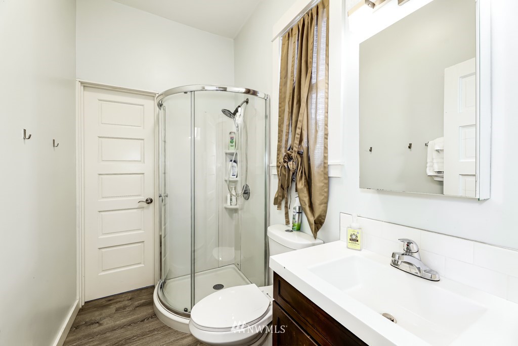 1611 East Spring Street Seattle, WA 98122 - Photo 22 of 36 a bathroom with a sink a toilet and shower