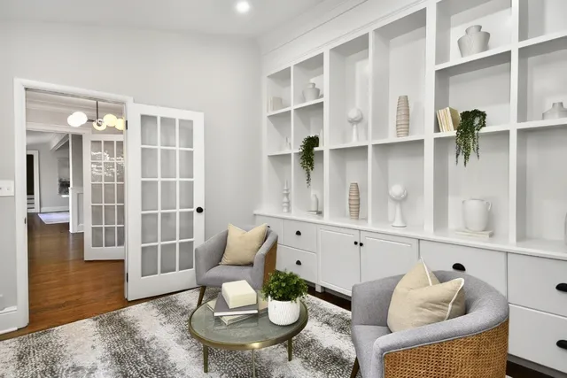 a living room with furniture cabinets and a table