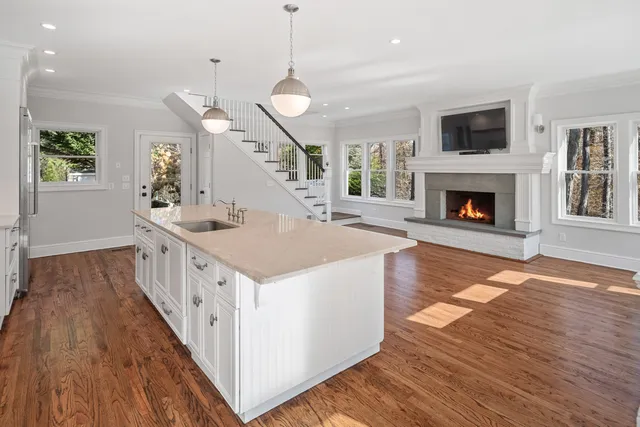 a kitchen with a stove and a wooden floor