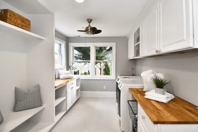 a living room with stainless steel appliances granite countertop furniture and a large window