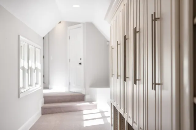 a view of a bedroom with wooden floor and windows