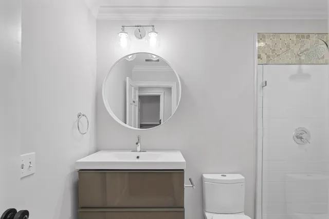 a bathroom with a toilet sink and mirror