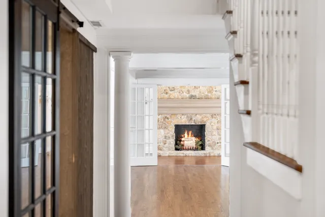 a view of an empty room with a fireplace and a window