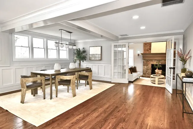 a living room with furniture a wooden floor and a fireplace