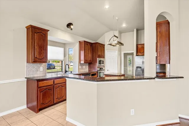 a kitchen with stainless steel appliances granite countertop a sink and cabinets