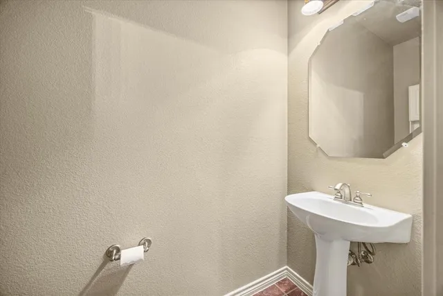 a bathroom with a sink and mirror
