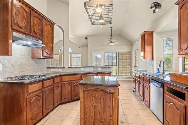 a kitchen with stainless steel appliances granite countertop a sink and stove