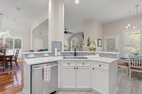 a kitchen with cabinets and chairs