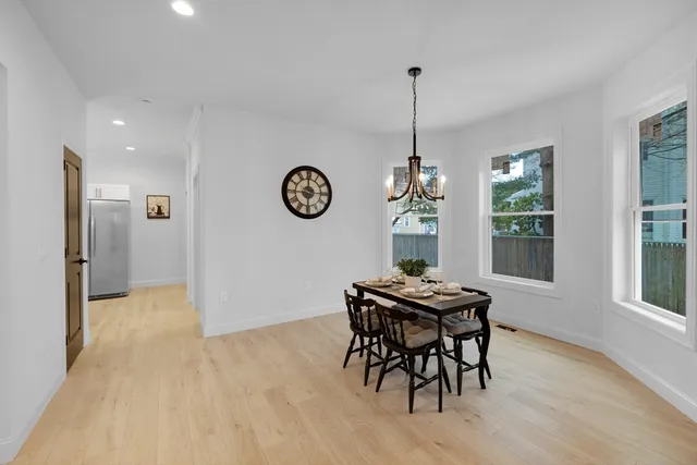 a view of a dining room with furniture window and wooden floor