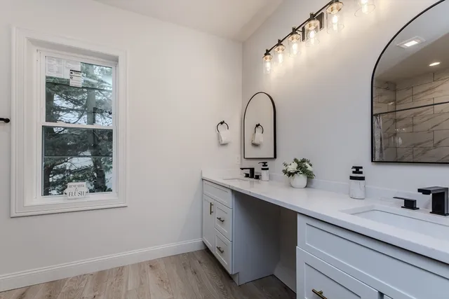 a bathroom with a double vanity sink and mirror