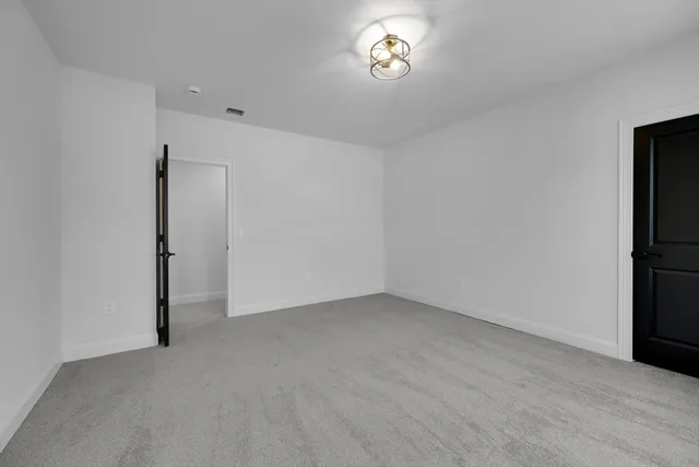 a bathroom with a granite countertop sink a toilet and shower