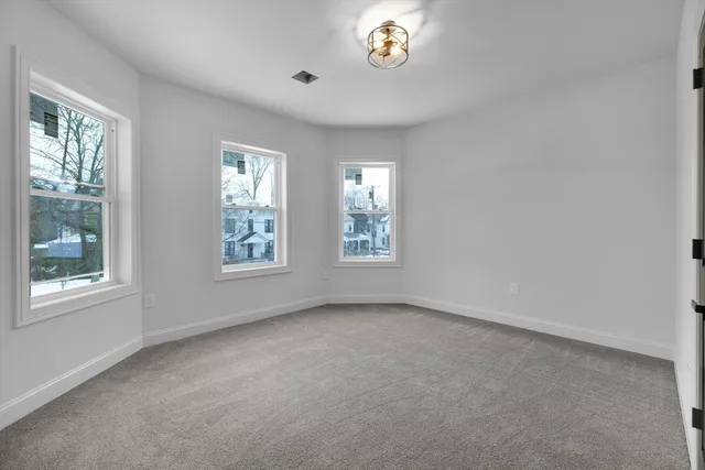 an empty room with windows and closet