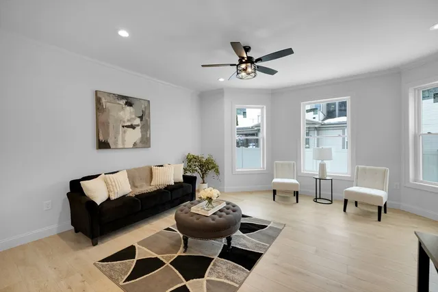 a living room with furniture a window and a chandelier