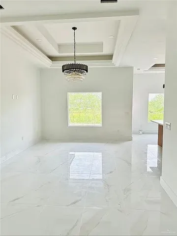 a view of an empty room and a window