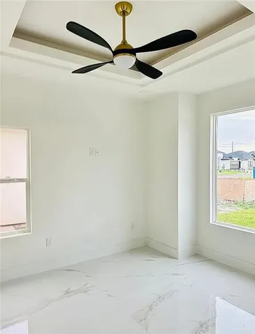 a view of a room with window and a ceiling fan