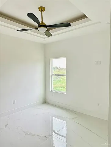 a view of room with a window and ceiling fan