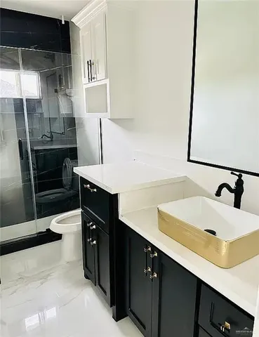 a kitchen with a sink refrigerator and cabinets