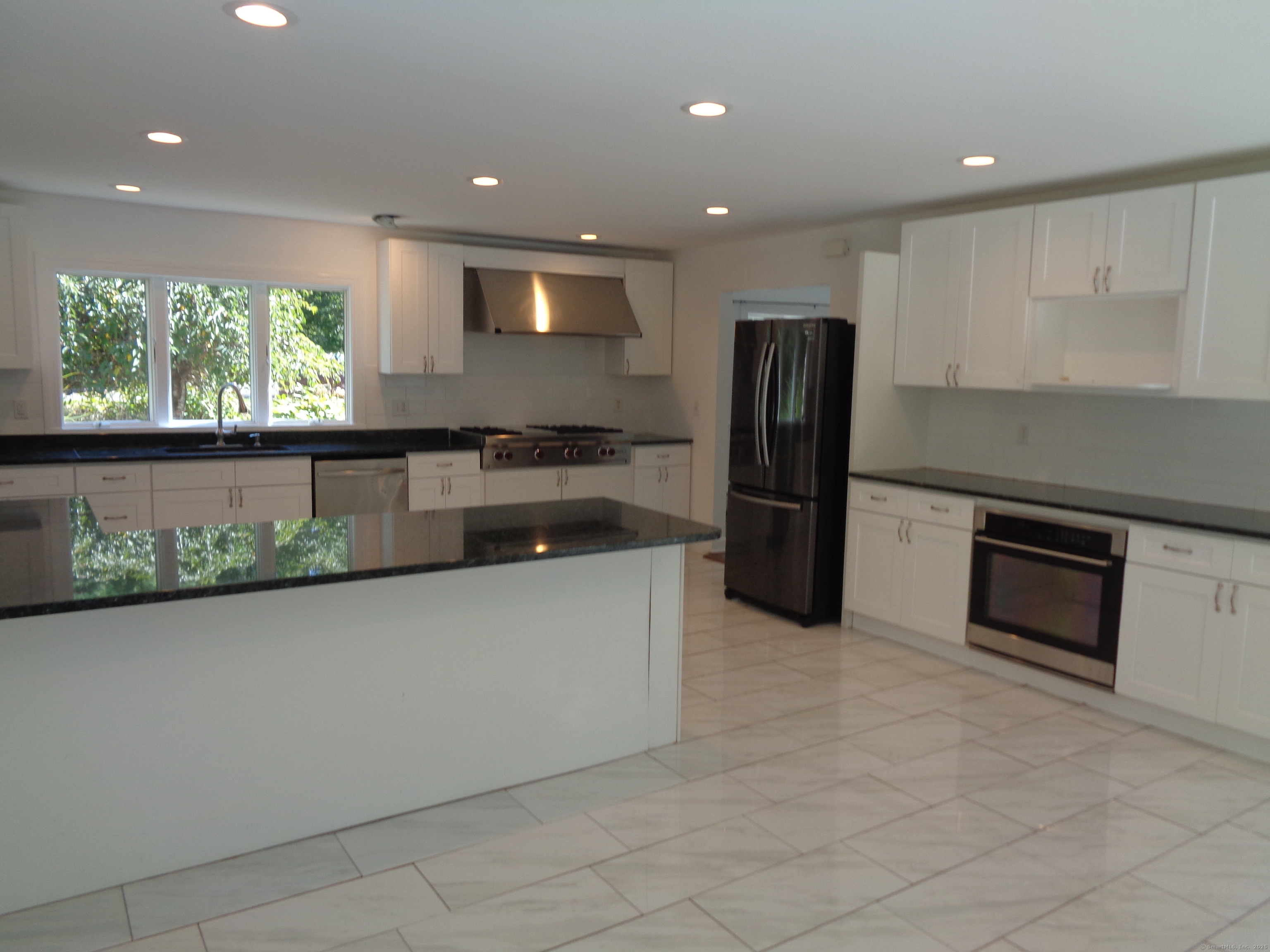 531 Hollow Tree Ridge Road Darien, CT 06820 - Photo 11 of 37 a kitchen with stainless steel appliances granite countertop a refrigerator and a sink
