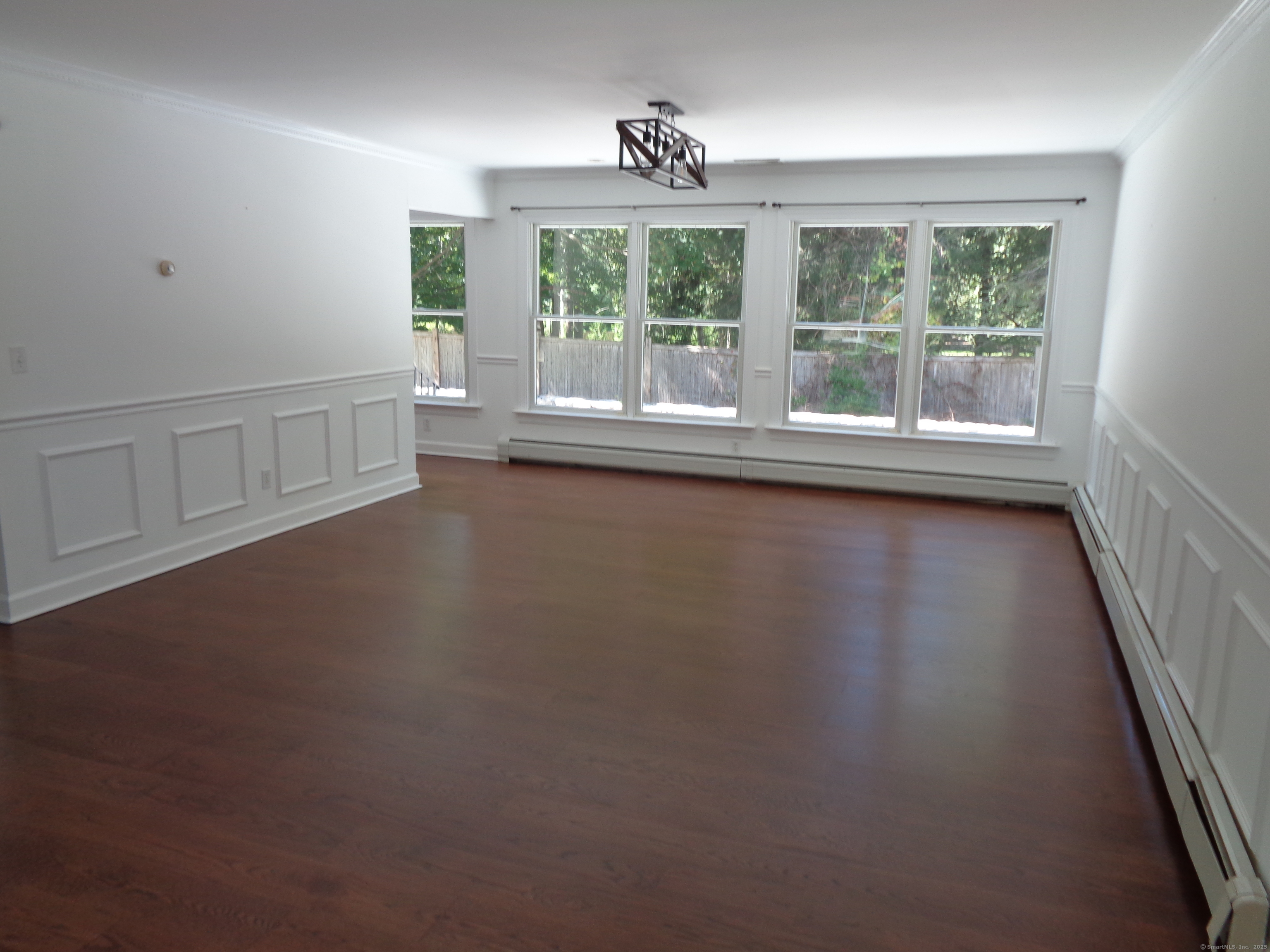 531 Hollow Tree Ridge Road Darien, CT 06820 - Photo 12 of 37 an empty room with wooden floor and windows