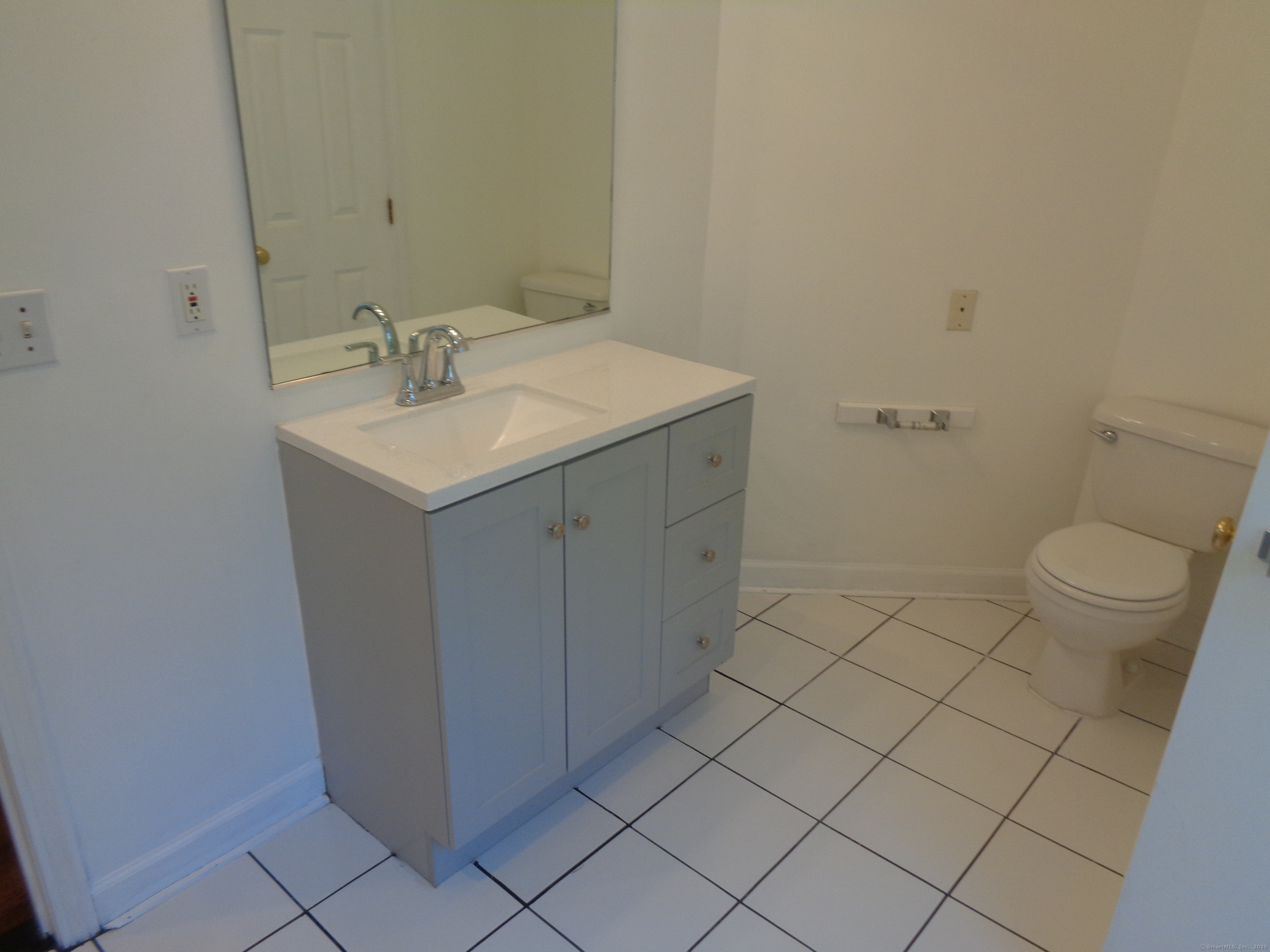 531 Hollow Tree Ridge Road Darien, CT 06820 - Photo 25 of 37 a bathroom with a sink toilet and vanity