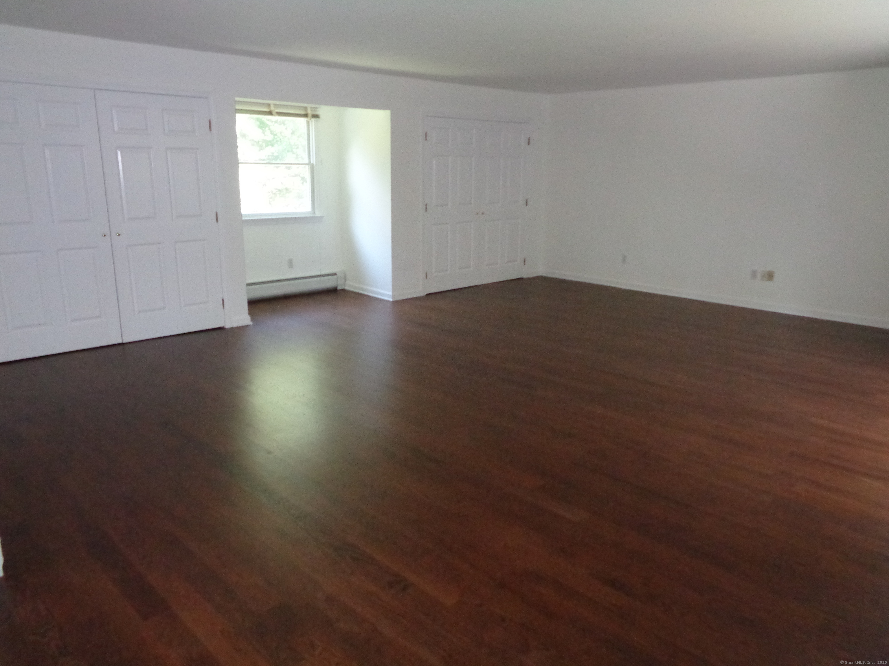 531 Hollow Tree Ridge Road Darien, CT 06820 - Photo 28 of 37 an empty room with wooden floor and windows