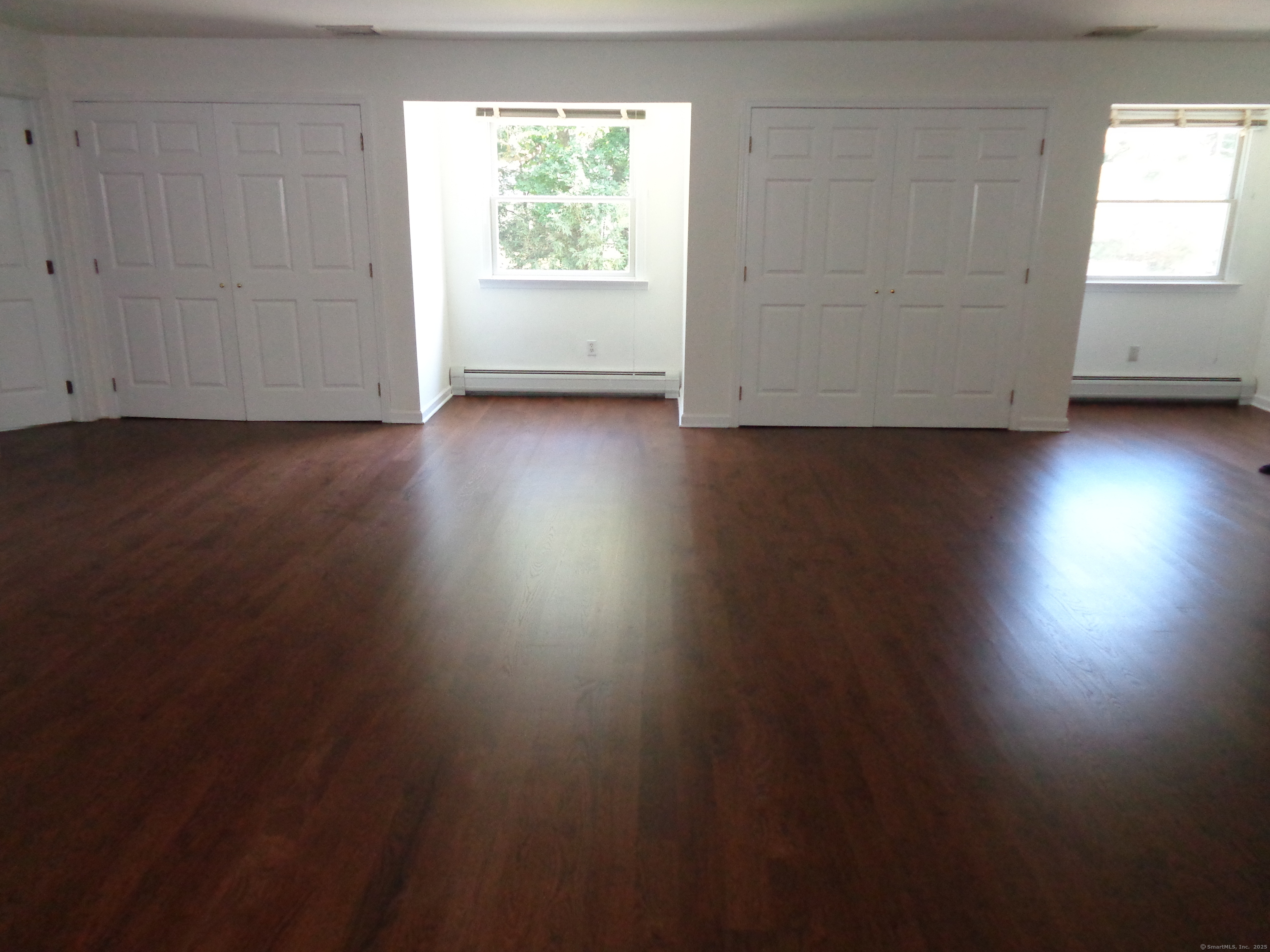 531 Hollow Tree Ridge Road Darien, CT 06820 - Photo 29 of 37 a view of an empty room with wooden floor and a window