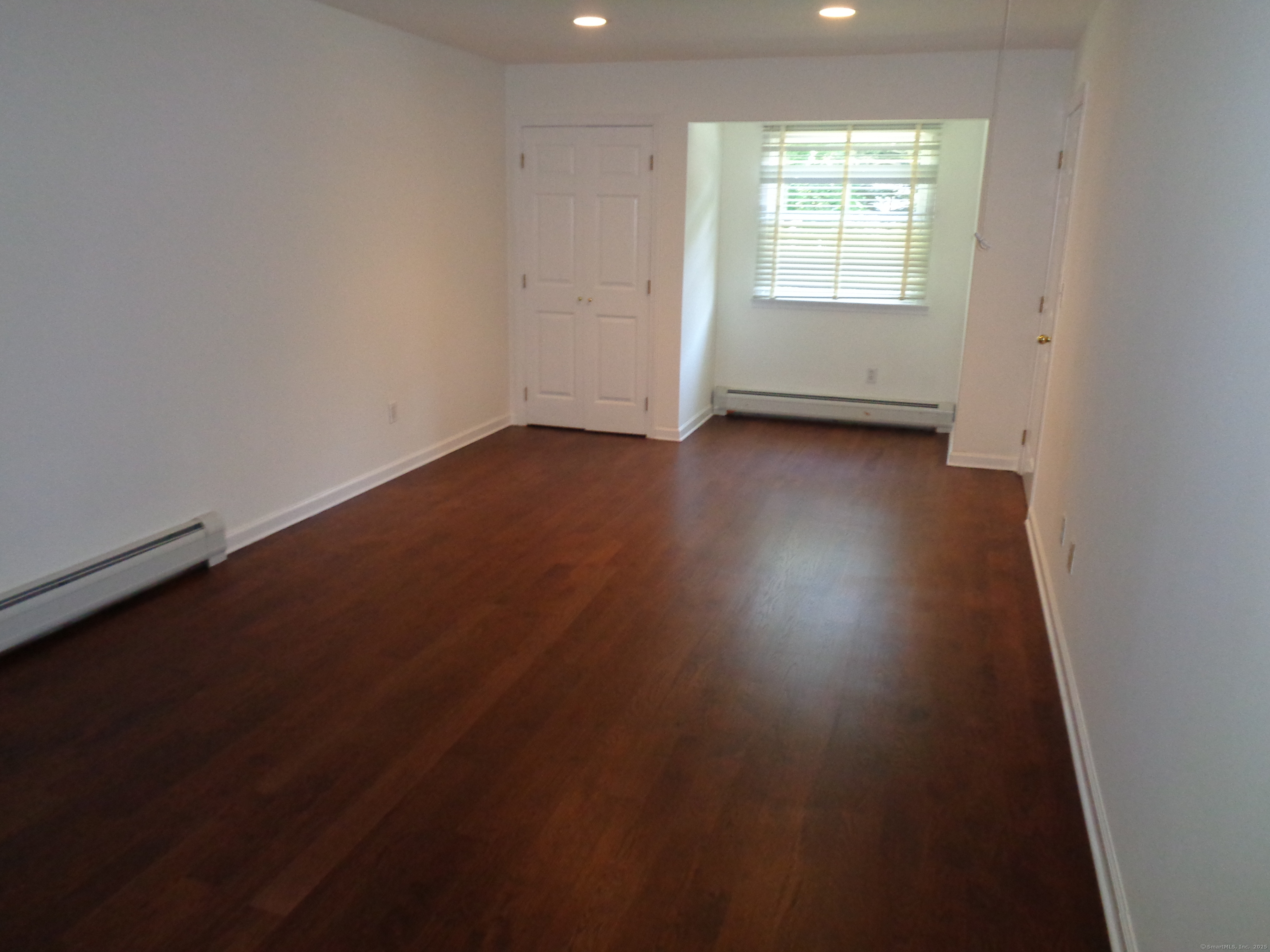 531 Hollow Tree Ridge Road Darien, CT 06820 - Photo 30 of 37 an empty room with wooden floor and windows