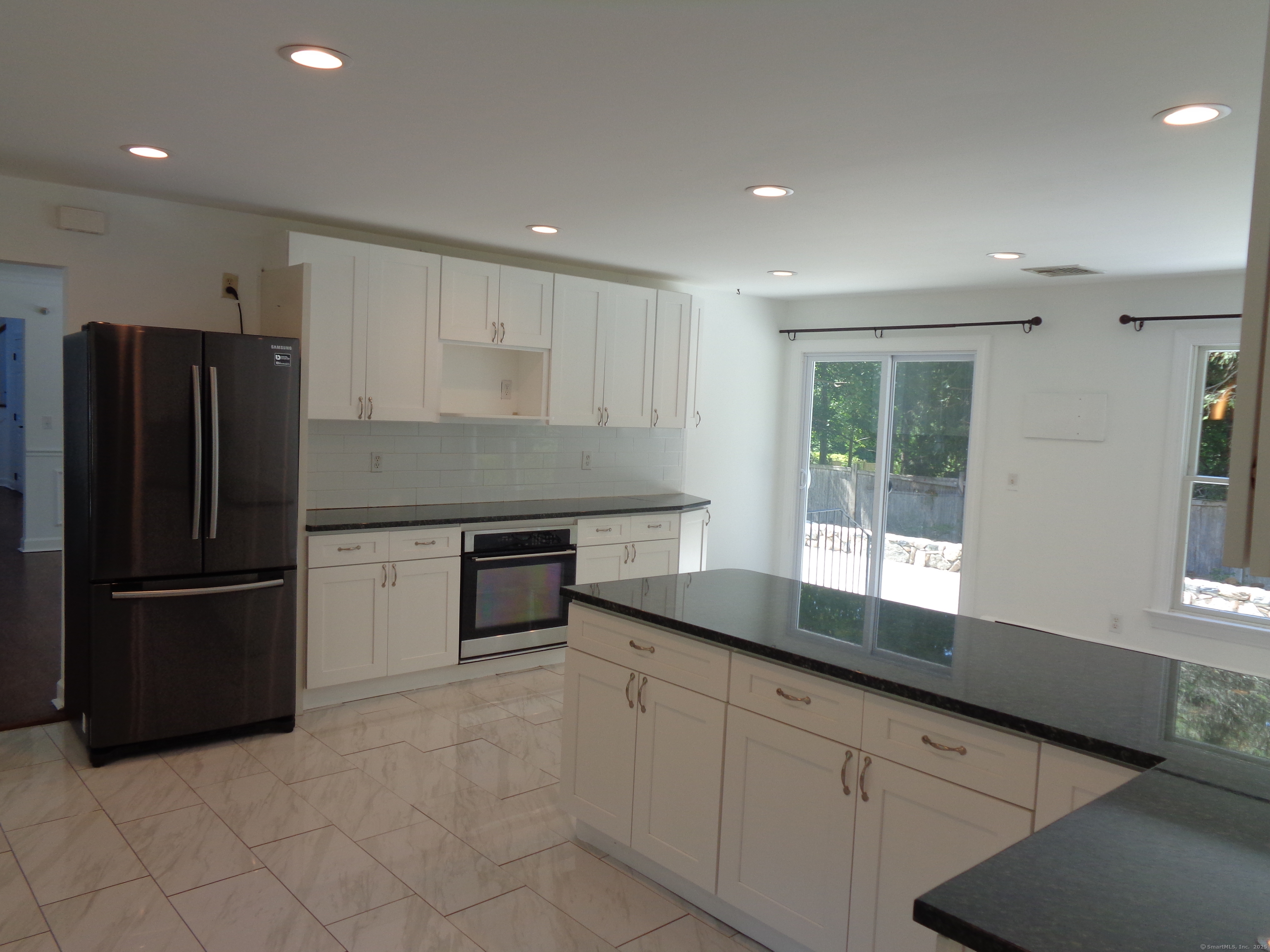 531 Hollow Tree Ridge Road Darien, CT 06820 - Photo 9 of 37 a kitchen with granite countertop a refrigerator and a sink