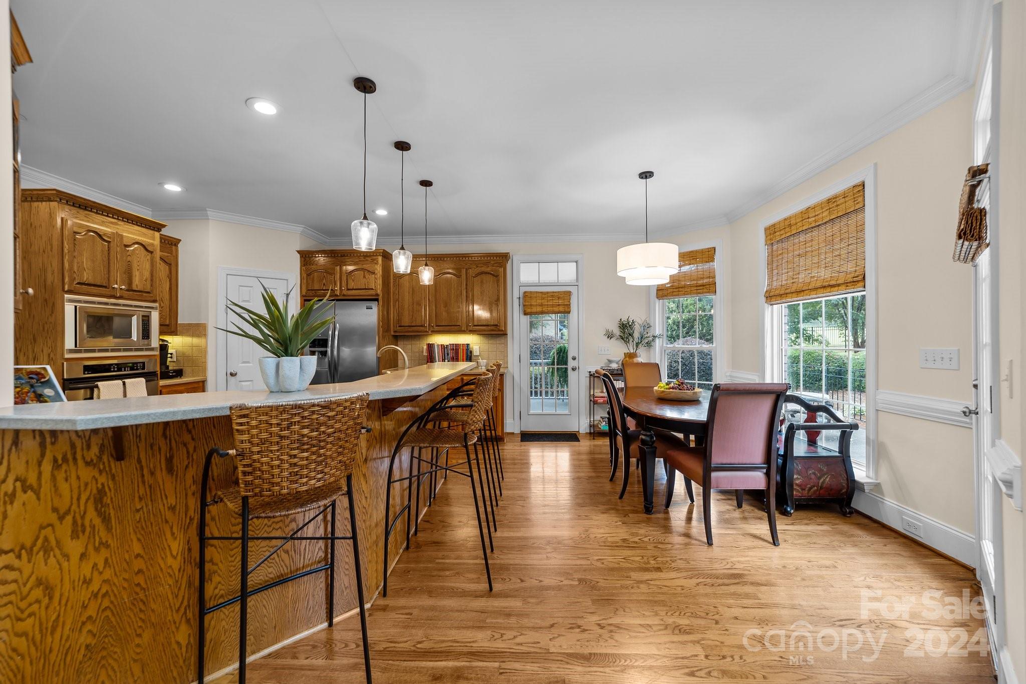 6370 Chamar Circle Kannapolis, NC 28081 - Photo 12 of 48 a dining room with furniture a chandelier and wooden floor
