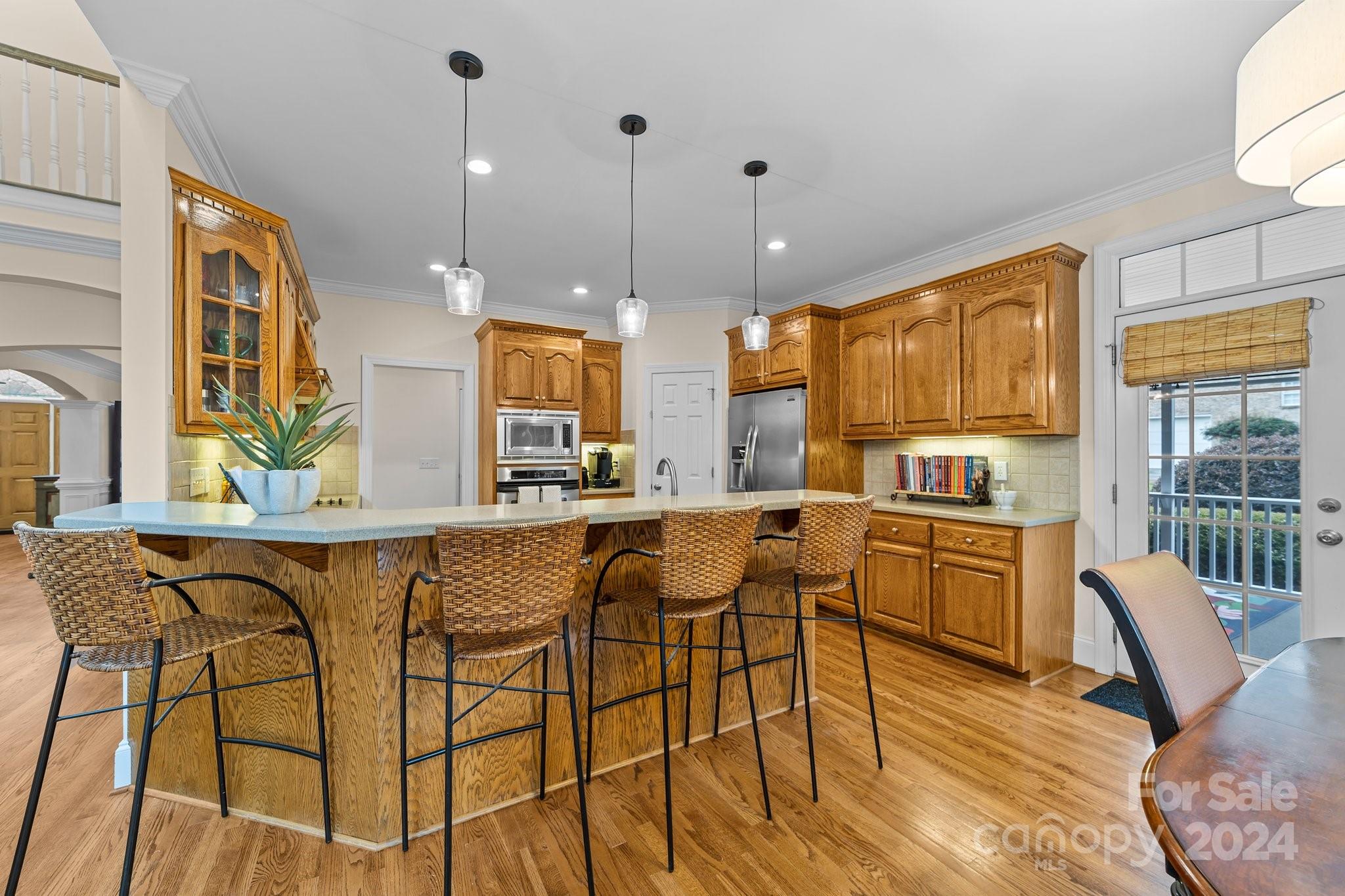 6370 Chamar Circle Kannapolis, NC 28081 - Photo 14 of 48 a kitchen with stainless steel appliances granite countertop a stove a sink a refrigerator dining table chairs and view living room
