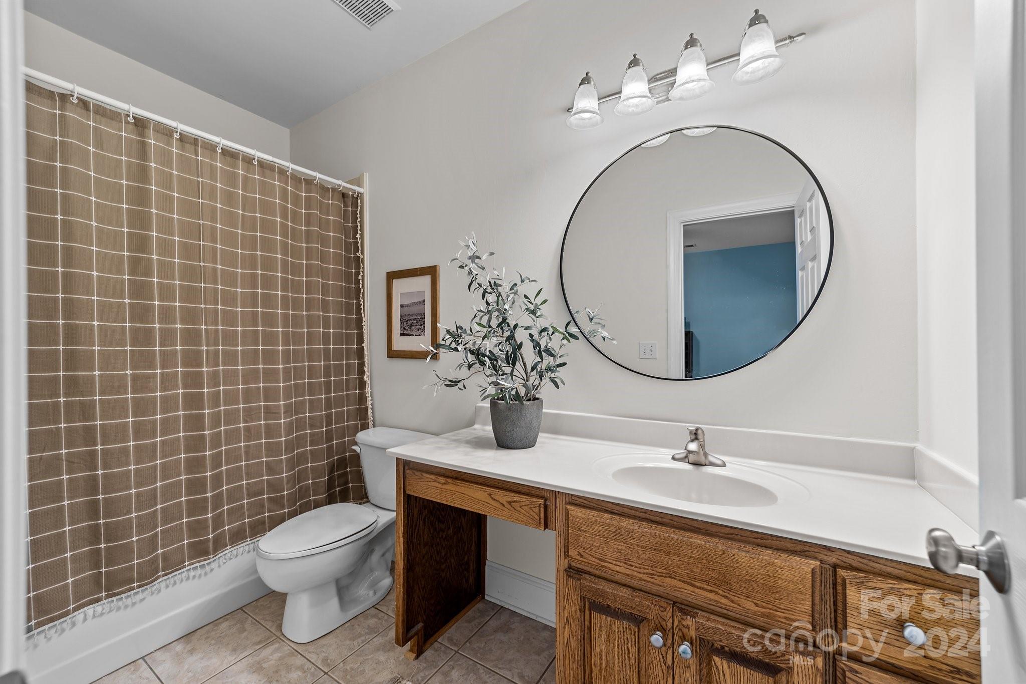 6370 Chamar Circle Kannapolis, NC 28081 - Photo 25 of 48 a bathroom with a toilet sink vanity and mirror