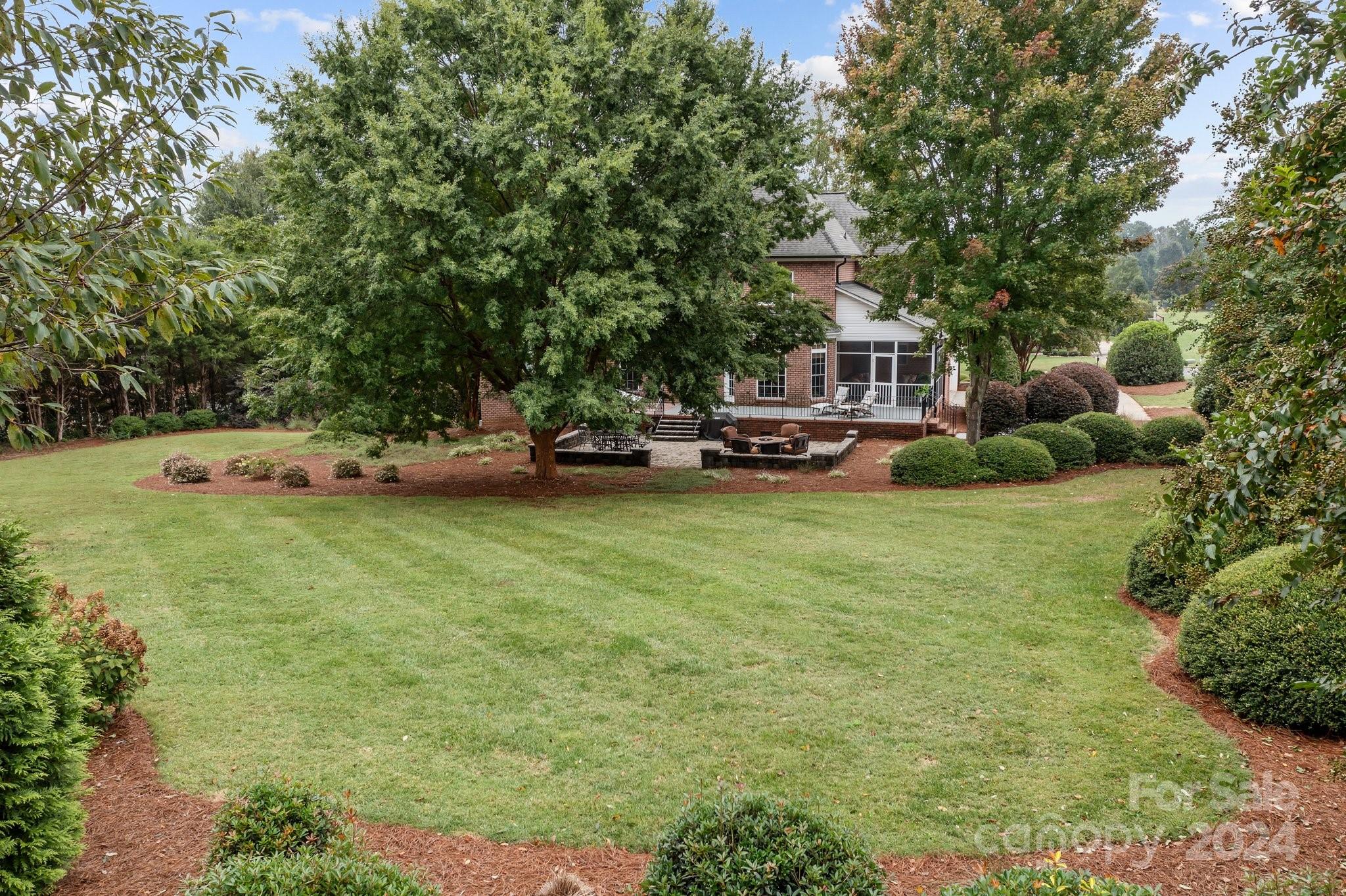6370 Chamar Circle Kannapolis, NC 28081 - Photo 37 of 48 a front view of a house with a garden and trees