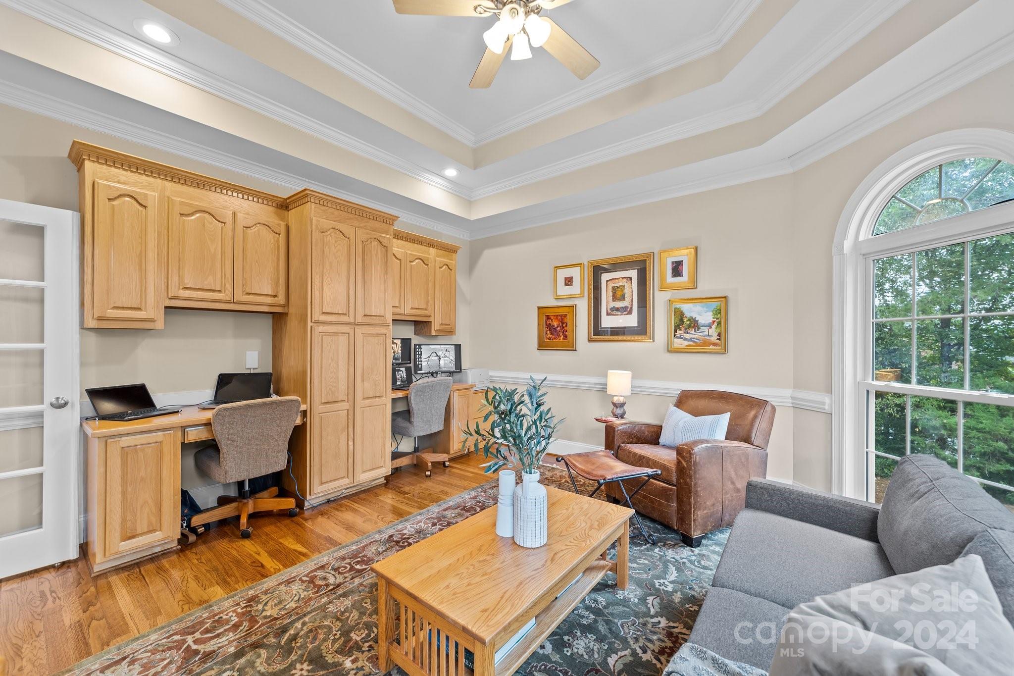 6370 Chamar Circle Kannapolis, NC 28081 - Photo 7 of 48 a living room with furniture a flat screen tv and a floor to ceiling window