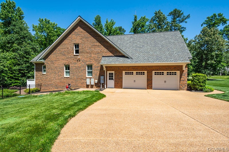 11624 Barrows Ridge Lane Chesterfield, VA 23838 - Photo 4 of 48 a front view of a house with a yard and garage