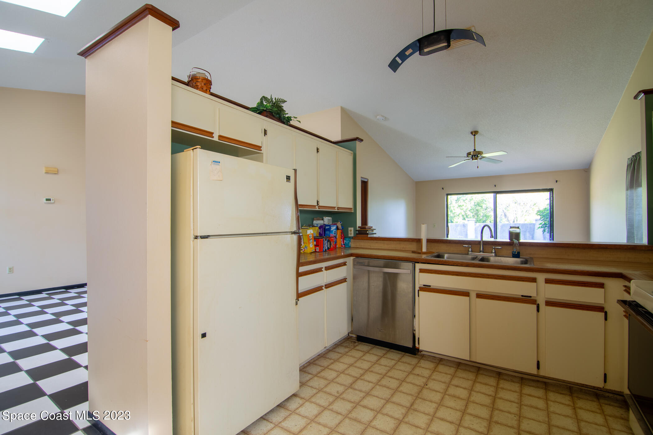 1816 Clover Circle Melbourne, FL 32935 - Photo 5 of 13 a kitchen with a refrigerator and a sink