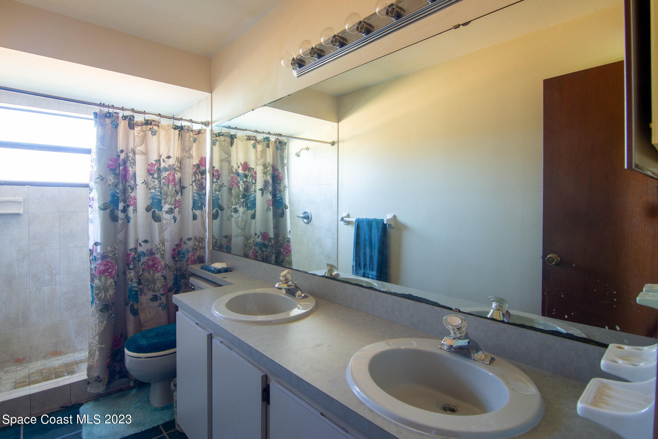 1816 Clover Circle Melbourne, FL 32935 - Photo 8 of 13 a bathroom with a sink toilet and shower