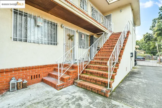 a view of a balcony with wooden floor and fence