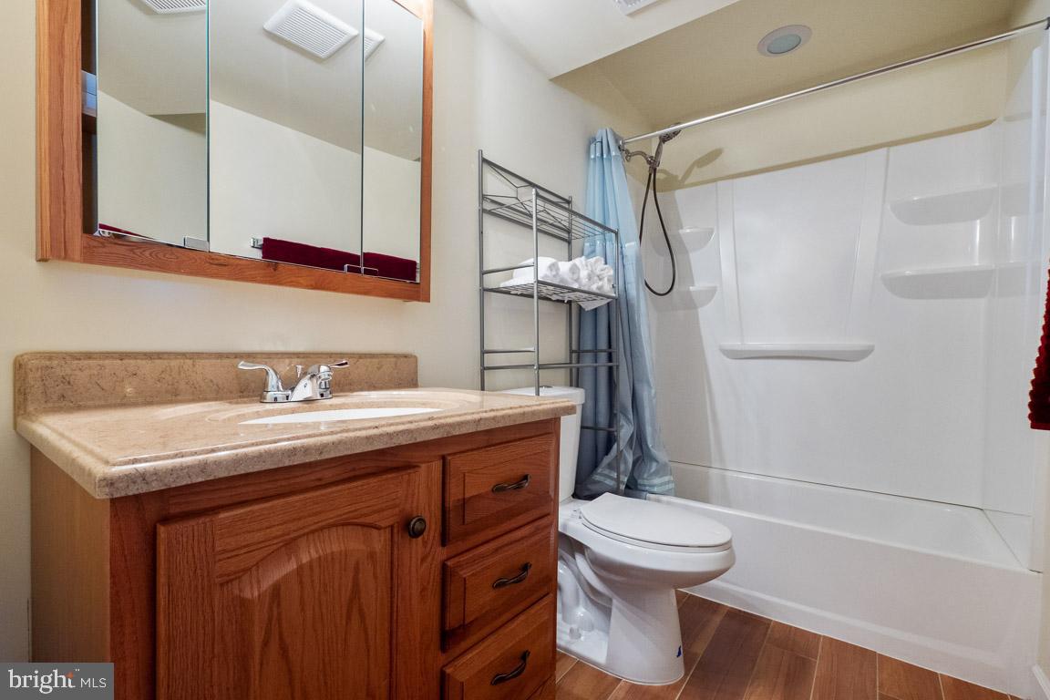 3100 Hemlock Point Court Triangle, VA 22172 - Photo 47 of 71 a bathroom with a granite countertop sink toilet a mirror and shower