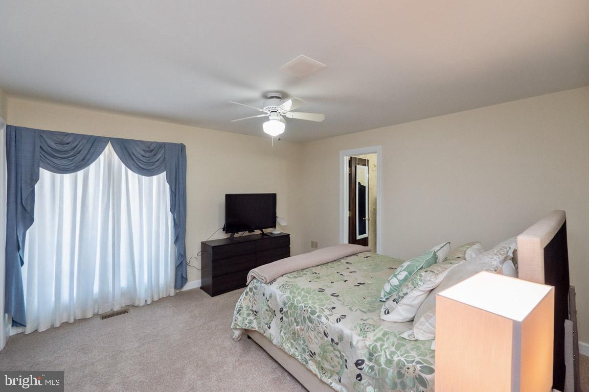 3100 Hemlock Point Court Triangle, VA 22172 - Photo 58 of 71 a bedroom with a bed and a flat screen tv