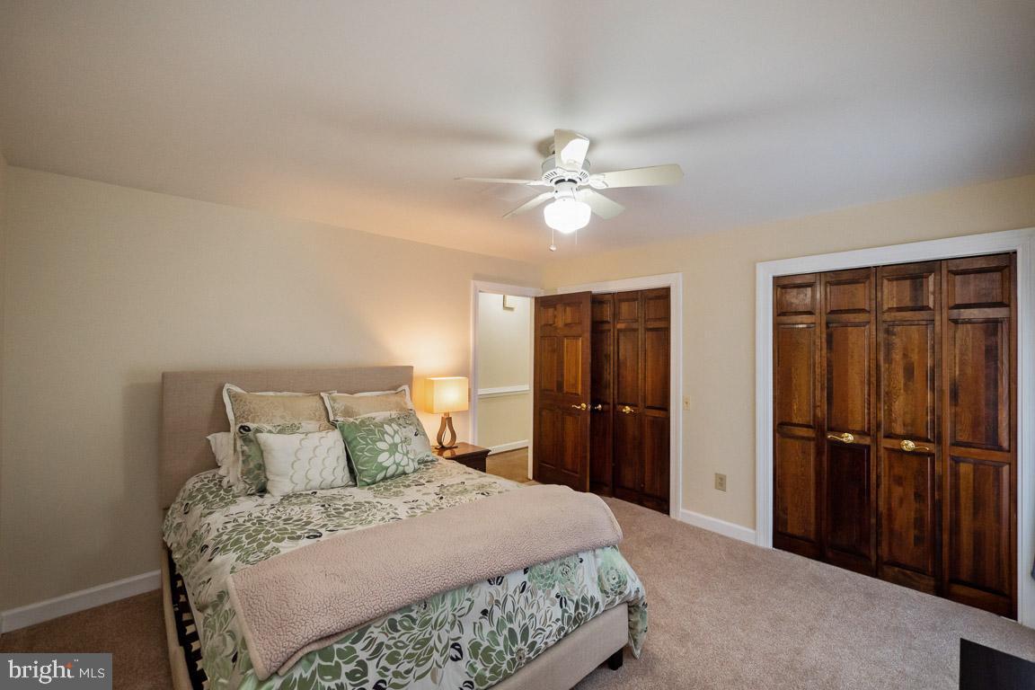 3100 Hemlock Point Court Triangle, VA 22172 - Photo 59 of 71 a bedroom with a bed and a chandelier