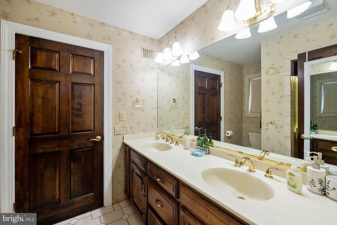 3100 Hemlock Point Court Triangle, VA 22172 - Photo 60 of 71 a bathroom with a sink double vanity and a mirror