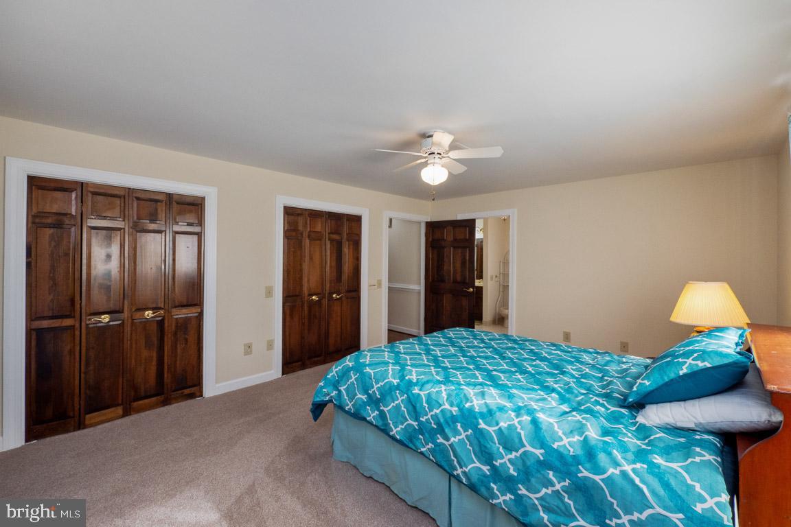 3100 Hemlock Point Court Triangle, VA 22172 - Photo 62 of 71 a bedroom with a bed and a chandelier