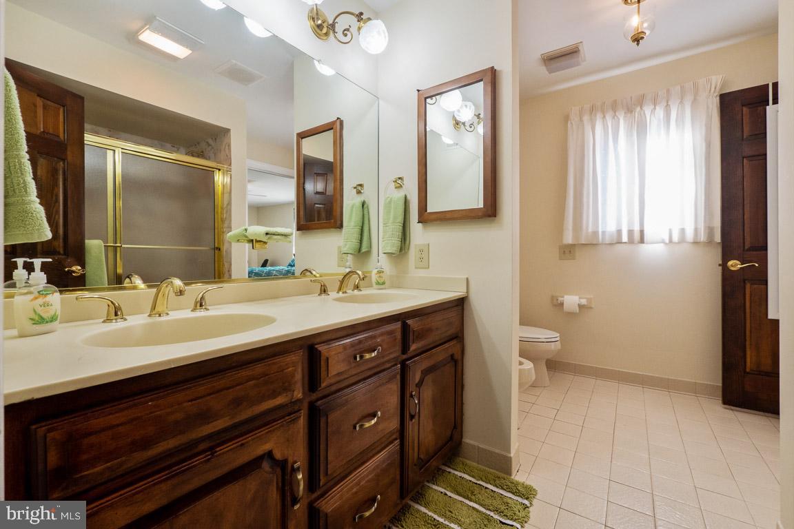3100 Hemlock Point Court Triangle, VA 22172 - Photo 64 of 71 a spacious bathroom with a double vanity sink a mirror and a toilet